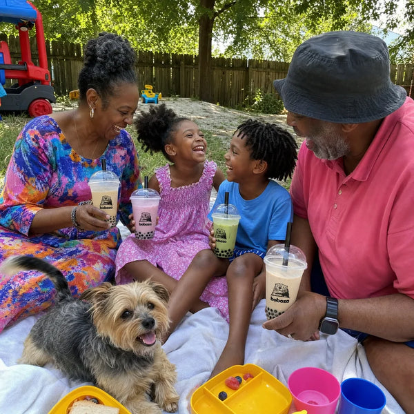 Grandparents enjoying boba in the backyard