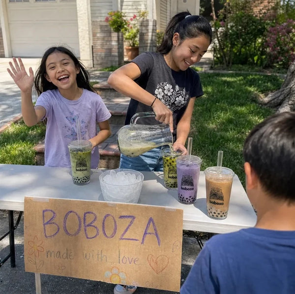 Kids running a homemade Boboza stand in the driveway, pouring a boba drink for their first customer